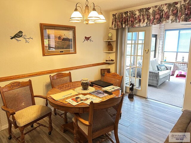 42 Cherokee Dr, Harlingen, TX 78550 - dining area featuring a chandelier and wood finished floors