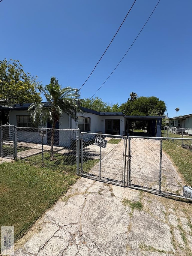view of front of home featuring a carport, fence, a gate, and concrete driveway