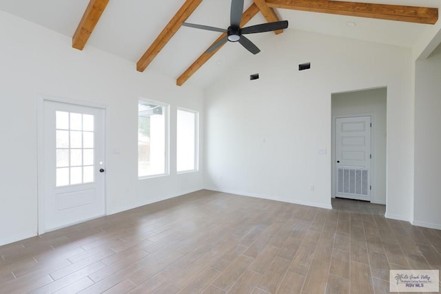 spare room with beamed ceiling, ceiling fan, and light hardwood / wood-style floors