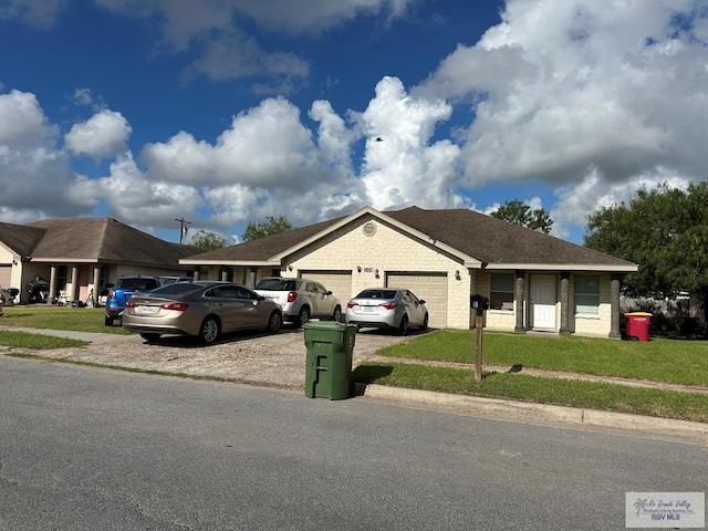 ranch-style house with a garage and a front yard