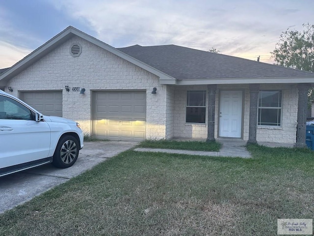 view of front of home featuring a yard and a garage