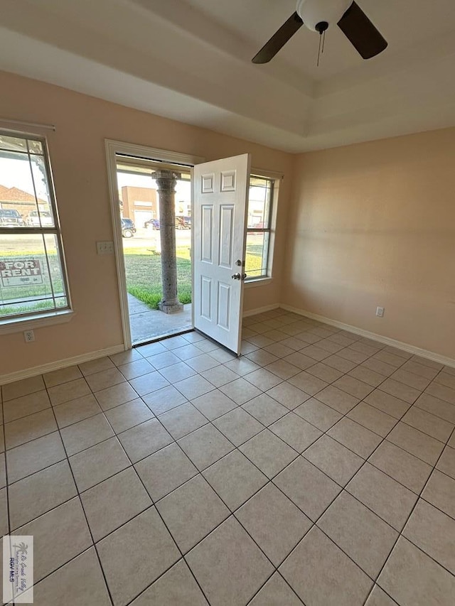 tiled foyer featuring plenty of natural light and ceiling fan