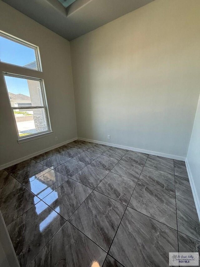 7377 San Andres St, Brownsville, TX 78520 - empty room with marble finish flooring and baseboards
