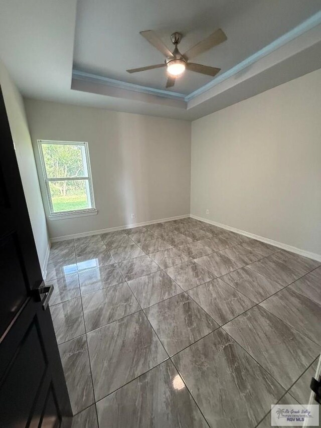 7377 San Andres St, Brownsville, TX 78520 - unfurnished room featuring a tray ceiling, a ceiling fan, baseboards, and marble look tiles