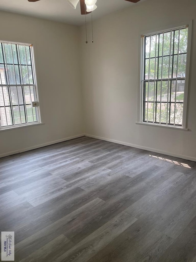 spare room featuring dark hardwood / wood-style floors and ceiling fan