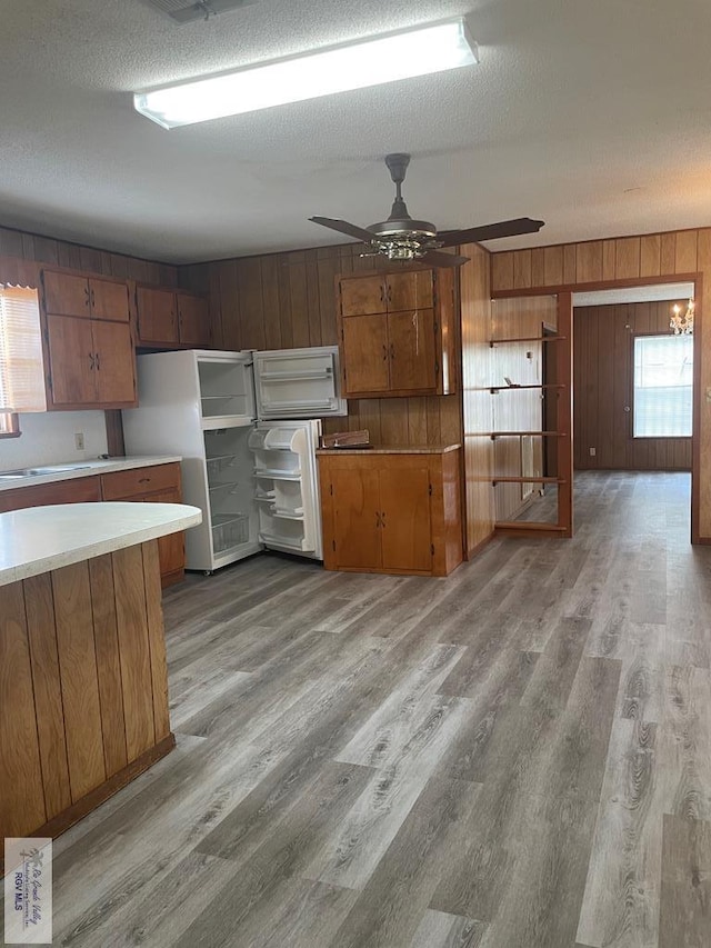 kitchen featuring white refrigerator, light hardwood / wood-style floors, and ceiling fan