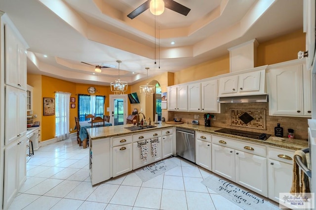 kitchen featuring white cabinets, a raised ceiling, dishwasher, a peninsula, and a ceiling fan