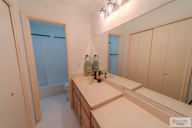 full bathroom featuring vanity, tile patterned floors, shower / bath combo with shower curtain, and toilet