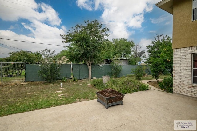 view of patio with fence and an outdoor fire pit