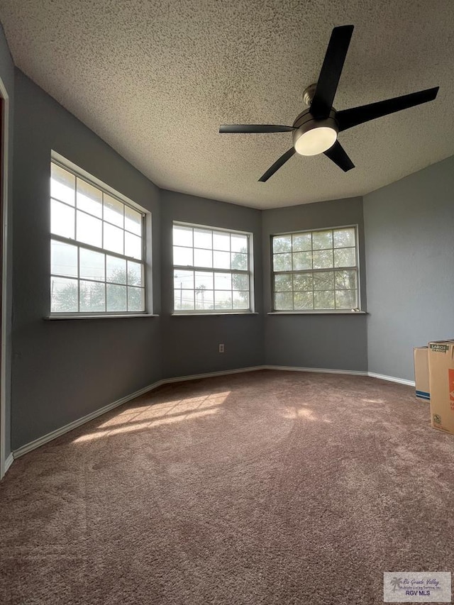 unfurnished room featuring ceiling fan, a textured ceiling, baseboards, and carpet floors