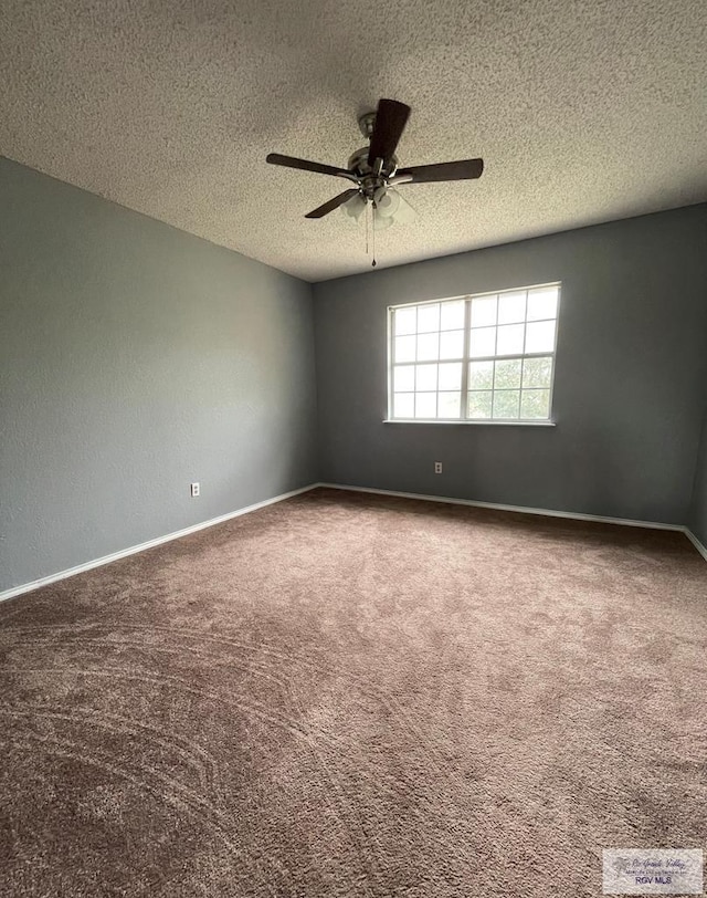 carpeted spare room with baseboards, a textured ceiling, and a ceiling fan