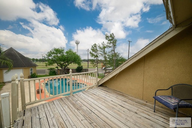 wooden terrace with a fenced in pool and fence