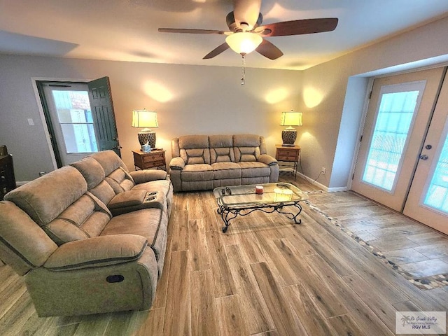 480 Madrid Ct, San Benito, TX 78586 - living area featuring wood finished floors, a ceiling fan, french doors, and baseboards