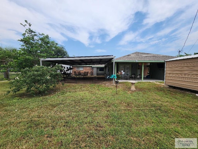 480 Madrid Ct, San Benito, TX 78586 - back of house featuring a lawn and a patio area