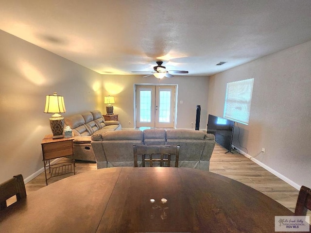 480 Madrid Ct, San Benito, TX 78586 - living room with baseboards, ceiling fan, light wood finished floors, and french doors