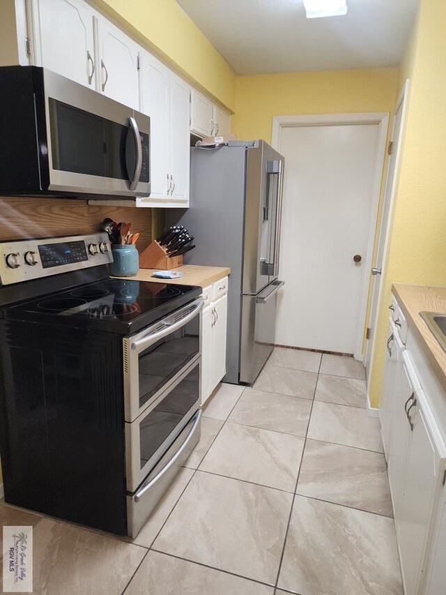 480 Madrid Ct, San Benito, TX 78586 - kitchen featuring appliances with stainless steel finishes, white cabinetry, and light countertops