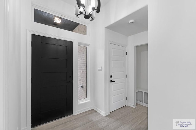 entryway featuring light hardwood / wood-style floors and an inviting chandelier