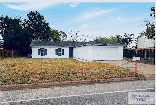 single story home featuring a front lawn, fence, and concrete driveway