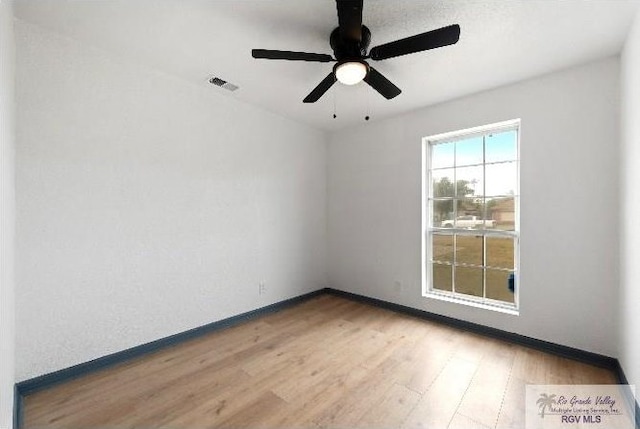 empty room featuring visible vents, baseboards, ceiling fan, and wood finished floors