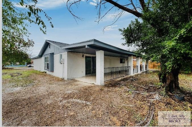 view of side of home with a patio
