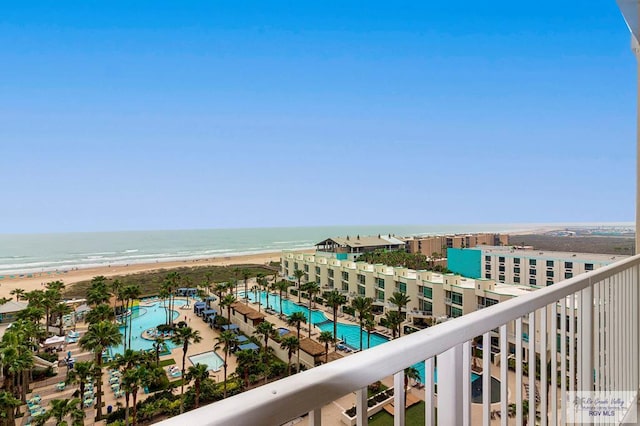 balcony featuring a water view and a beach view