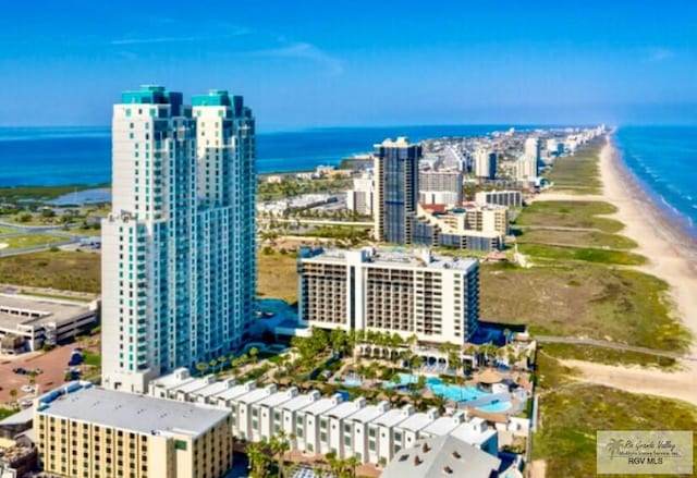 bird's eye view featuring a water view and a beach view