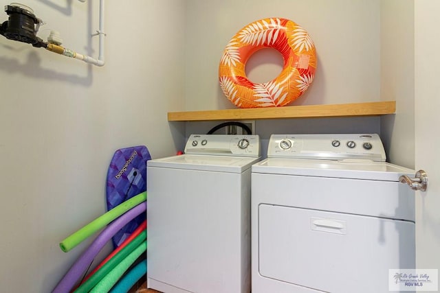 washroom with washer and dryer