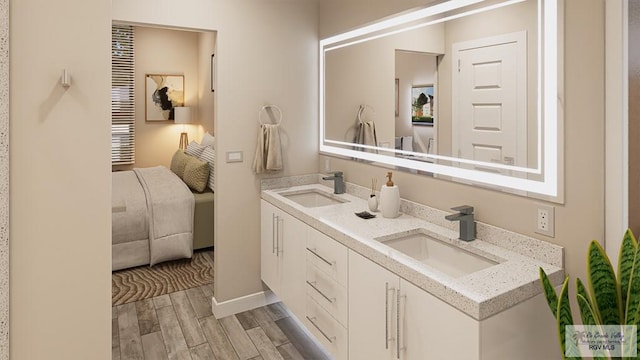 230 Cameo Dr, San Benito, TX 78586 - ensuite bathroom with double vanity and wood finished floors