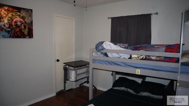 bedroom with dark hardwood / wood-style floors