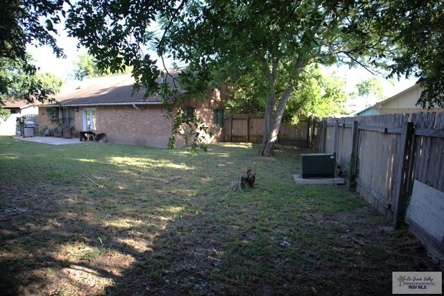 view of yard featuring a patio and central AC