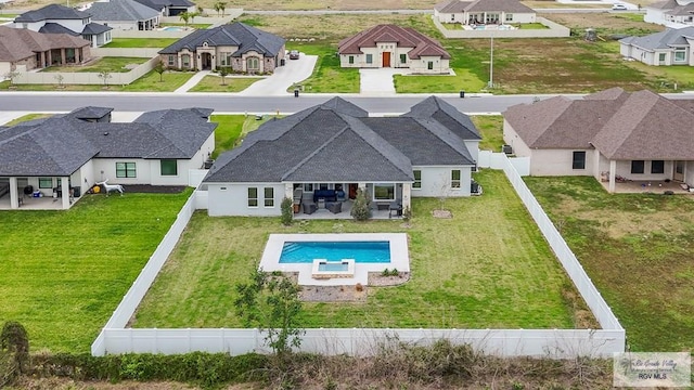 view of pool with a fenced in pool, a patio, a fenced backyard, a residential view, and a yard