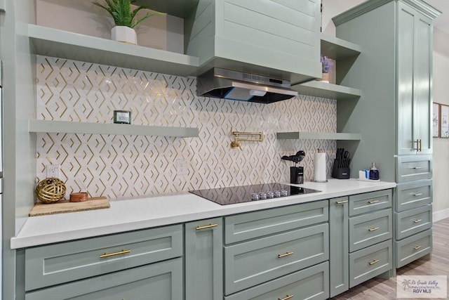 kitchen with decorative backsplash, custom exhaust hood, black electric stovetop, light countertops, and open shelves