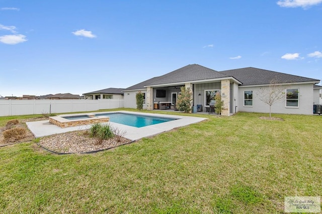 back of property with a pool with connected hot tub, a fenced backyard, a lawn, and a patio