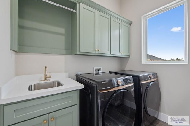 laundry area with a sink, cabinet space, and washer and dryer