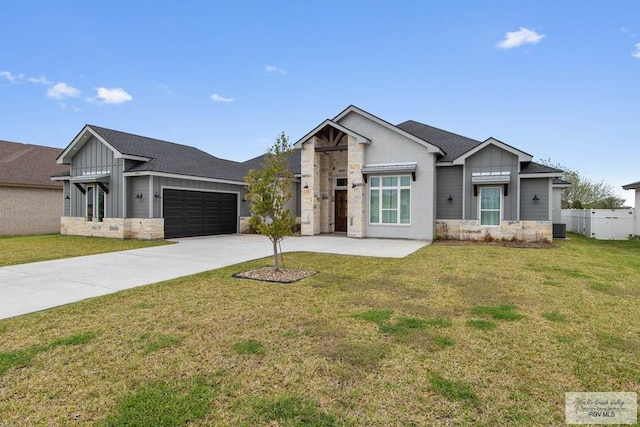 view of front of house with an attached garage, stone siding, board and batten siding, and concrete driveway