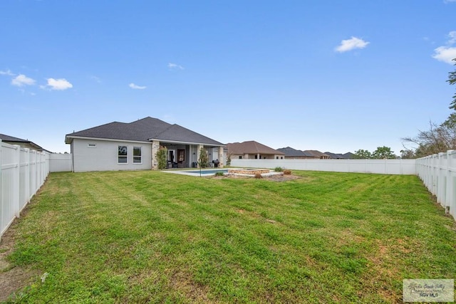 back of property featuring a fenced in pool, a fenced backyard, and a yard