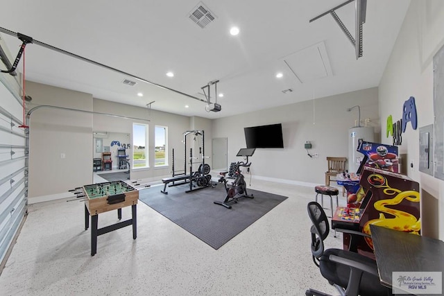 exercise area with a garage, attic access, visible vents, water heater, and recessed lighting