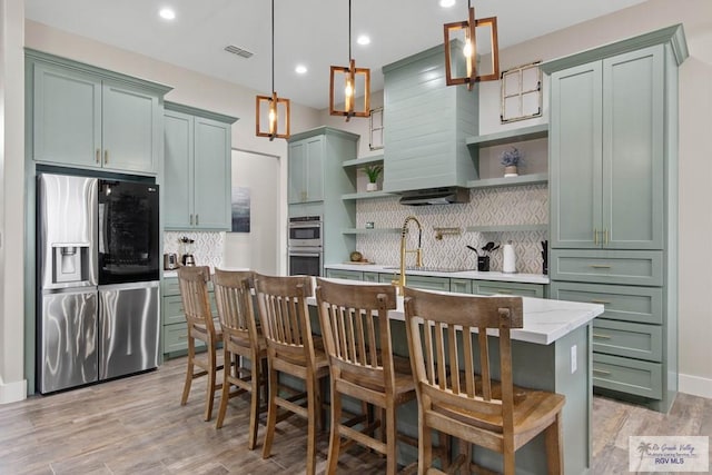 kitchen featuring visible vents, decorative backsplash, stainless steel appliances, open shelves, and green cabinetry