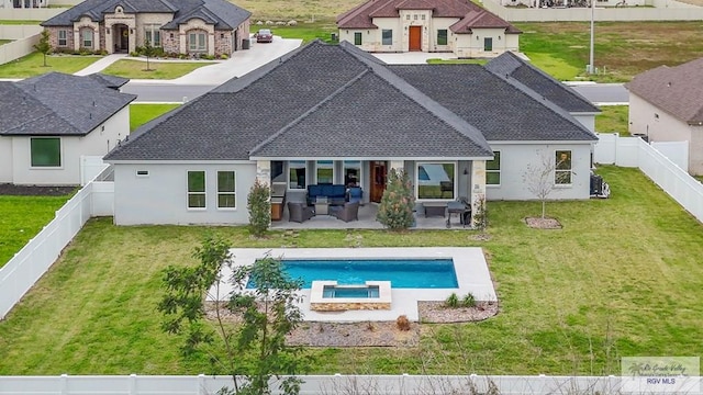 back of house featuring a yard, a patio area, a fenced backyard, and a pool with connected hot tub