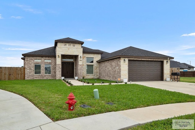 prairie-style house with a garage and a front yard