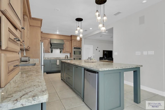 kitchen with pendant lighting, gray cabinets, light stone counters, and a spacious island