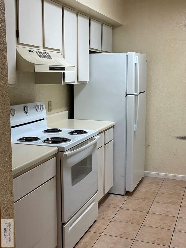 4601 S Carmen Ave Unit 2603, Rancho Viejo, TX 78575 - kitchen featuring white cabinets, white electric range, and light tile patterned flooring