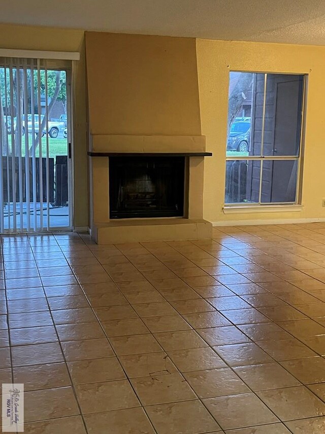 4601 S Carmen Ave Unit 2603, Rancho Viejo, TX 78575 - unfurnished living room with tile patterned floors