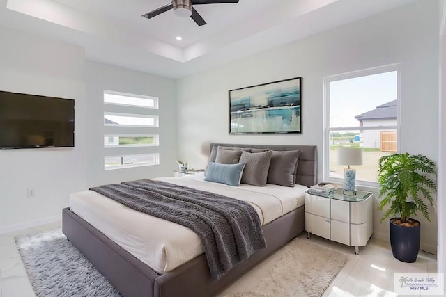 bedroom featuring multiple windows and ceiling fan