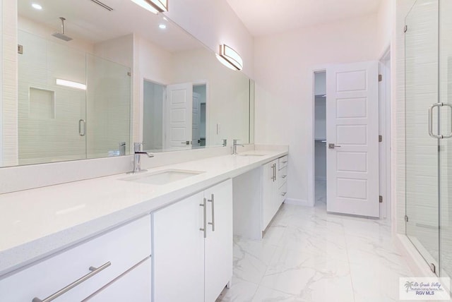 bathroom featuring vanity and an enclosed shower