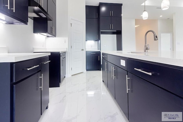 kitchen featuring extractor fan, hanging light fixtures, and sink