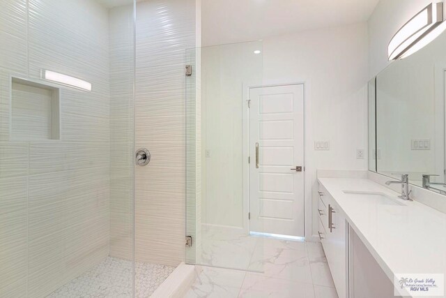 bathroom with vanity and an enclosed shower