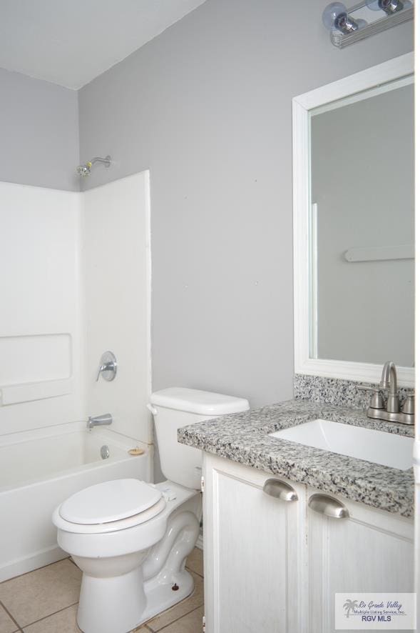 full bathroom with tile patterned flooring, vanity, shower / bathtub combination, and toilet