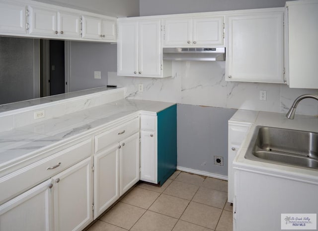 kitchen featuring sink, light tile patterned floors, ventilation hood, backsplash, and white cabinets