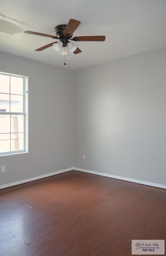 empty room featuring ceiling fan and dark hardwood / wood-style flooring